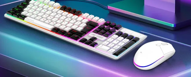 Modern PC setup on a white desk featuring five must-have accessories: an ergonomic keyboard, wireless mouse, high-resolution monitor, docking hub, and premium headphones.